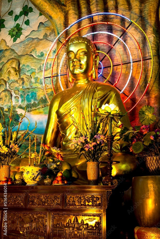 Sticker Golden Buddha statue with neon circles in Pagoda in Vietnam