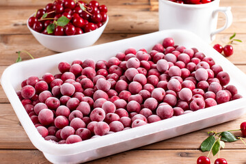 Frozen cherries on a wooden table. Frozen food