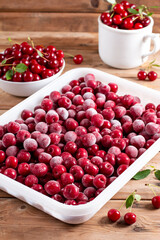 Frozen cherries on a wooden table. Frozen food