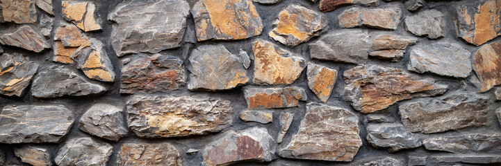 Stone wall. Wall of hewn wild stone. Stone background.