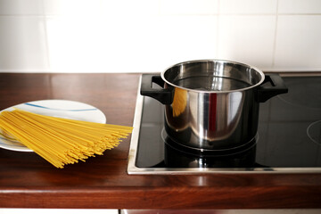 spaghetti pot on induction hob. home italian cuisine