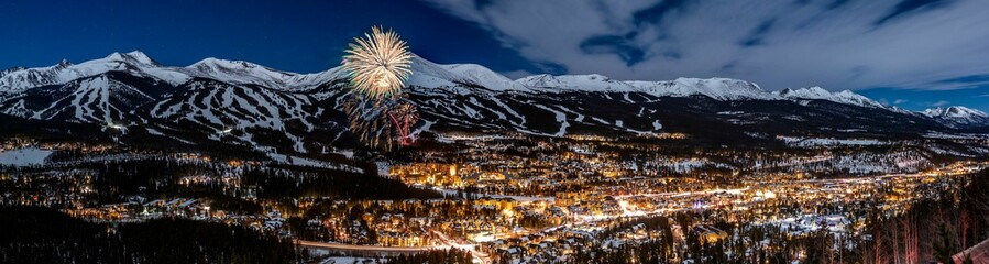 Panoramic view of New Year's Eve fireworks against snowy mountains in Breckenridge, Colorado