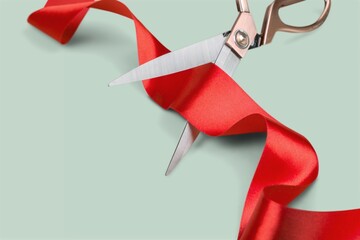 Grand opening with red ribbon and scissors. Cut a red ribbon on a light background.
