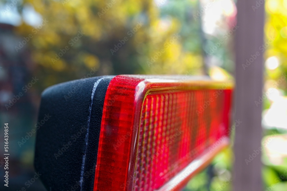 Sticker Closeup shot of a red break light on a car