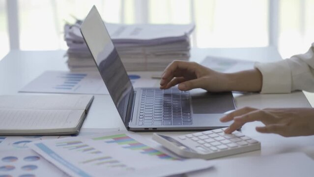 A businesswoman uses a calculator to work on financial reports. start a new business on the table with a cup of coffee and a data sheet Small Business Finance Ideas 4k Video