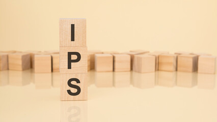 ips - acronym from wooden blocks with letters, investment policy statement concept on yellow...