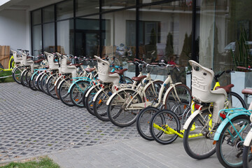 Hotel bike rental - a number of bikes standing in front of the building