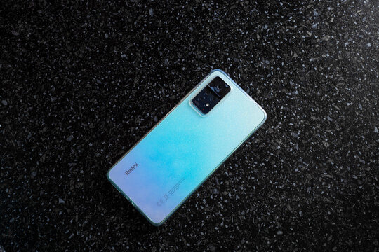 Mobile phone Redmi Note 11 Pro on a black surface. Device with trendy color