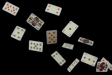 Flying playing cards on a black background.
