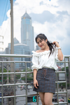 smiling woman standing happily in the park