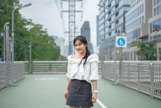 smiling woman standing happily in the park
