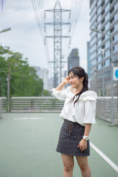 smiling woman standing happily in the park
