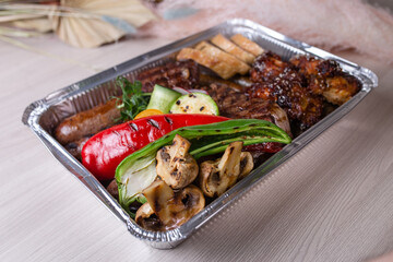 delivery of meat dishes in a foil box