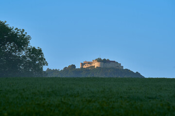 The castle (Hohen Neuffen) in the early morning in autumn. Defense building from the Middle Ages on a hill. Blue sky.