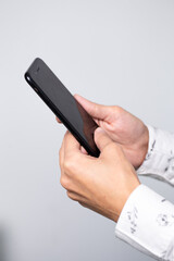 black smartphone in men's hands close-up on a white background