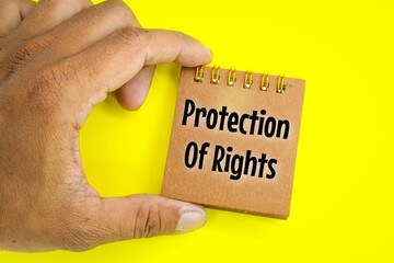 hand holding a notebook with the words protection of rights