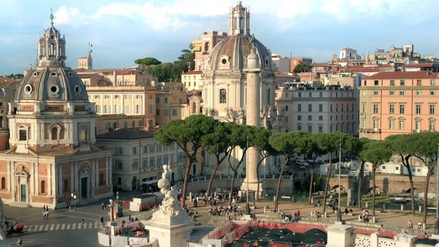 Street scape of the ancient centre of Rome, Italy. Santa Maria di Loreto and Trajan Column, walking people, old buildings