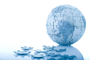 Metallic Globe Jigsaw Puzzle with Pieces Around on White Background