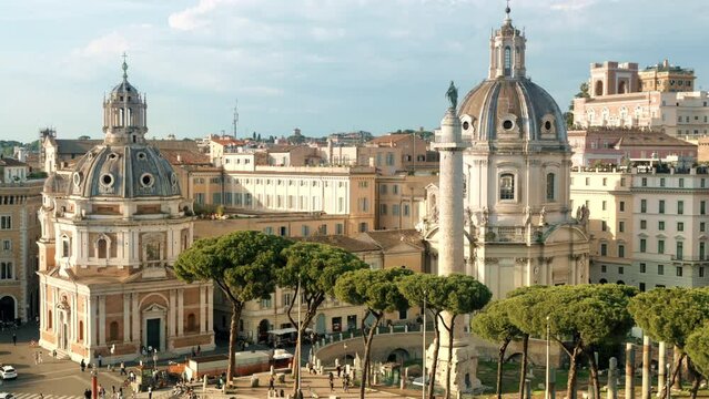 Street scape of the ancient centre of Rome, Italy. Santa Maria di Loreto and Trajan Column, walking people, old buildings