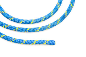 durable colored rope for climbing equipment on a white background. coil of braided cable. item for...