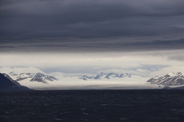 snowy mountains over looking the sea 