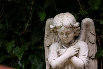 Closeup shot of a guardian angel statue against a nature background