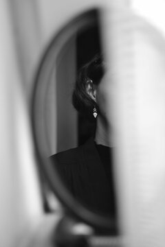 Shallow Focus Of A Woman's Side Profile Reflection In The Mirror