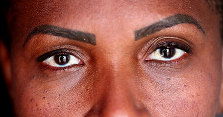 Naklejka premium African female eyes staring camera, macro close-up woman eye black ethnicity