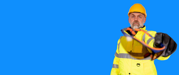  builder in helmet, bright yellow reflective hi-visibility fleeceand  safety gloves white background with space for text giving safety glasses.  