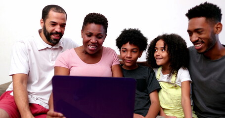 African interracial family speaking on video conference with relatives on laptop webcam
