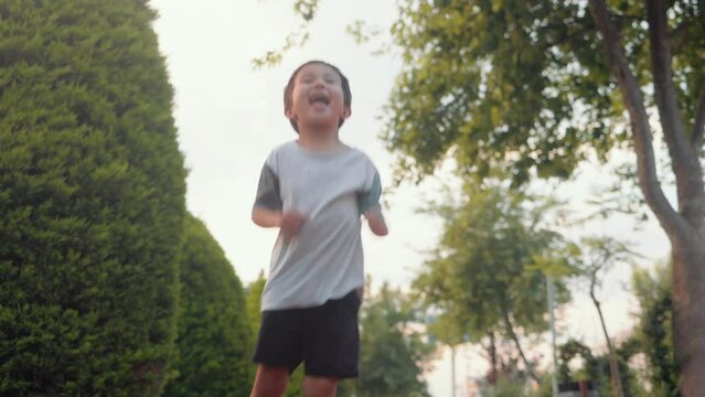 Exited asian boy jumping and dances. Happy family concept