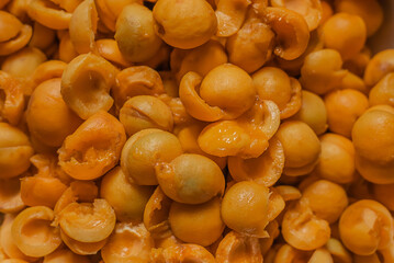 Background of bright,ripe yellow and orange apricots.Pile of fresh,juicy apricots scattered in bowl.The texture of fruit halves,slices the workpiece to jam.Summer harvest,canning concept.Farmer worked