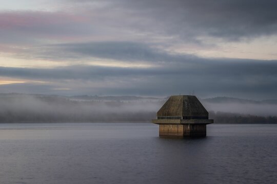 Breathtaking view of the Valve tower in Kielder Reservoir on cloudy sky background
