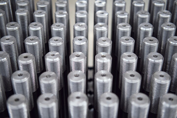 Many metal screw bolts as industrial equipment background