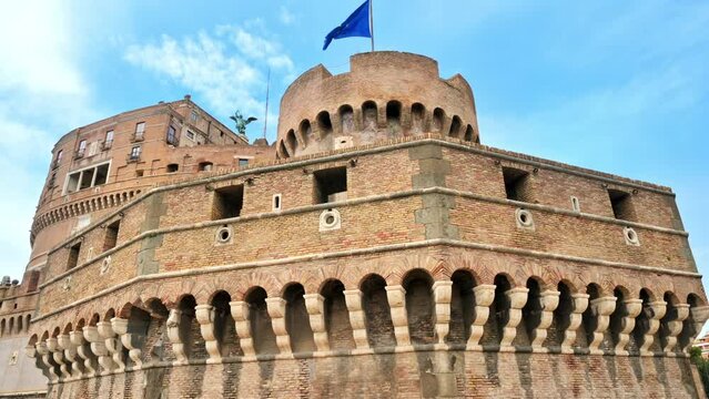 View of the Castle of the Holy Angel with walls in front of it in Rome, Italy