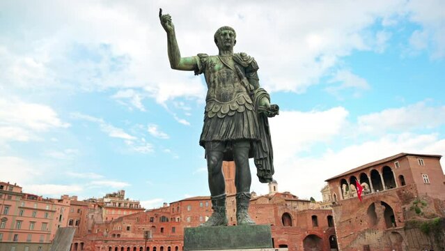 Statue of Augustus Caesar with ancient buildings on the background in Rome, Italy