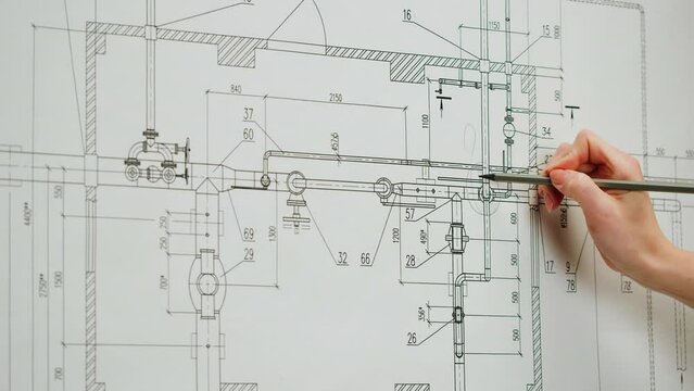 Architect designer working with plan blueprint close-up. Professional engineer showing on scheme, interior creator making architectural house project, drafting building.