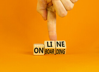 Online onboarding symbol. Concept words Online onboarding on wooden cubes. Businessman hand. Beautiful orange table orange background. Business and online onboarding concept. Copy space.