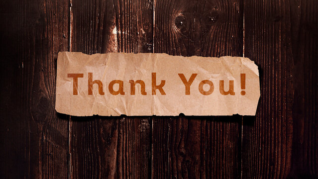"Thank you" Message for card, presentation and work. Rustic design on wooden background with kraft paper cut out. Can be used for business, marketing and advertising.