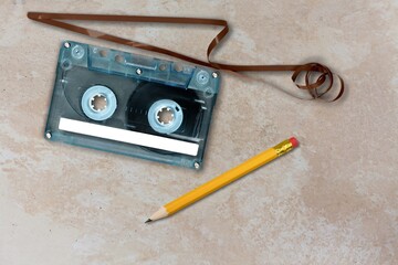 A pen for rewind cassette tape compact retro on background. 90's concepts.