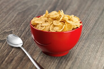 Corn flakes with milk in bowl on the desk