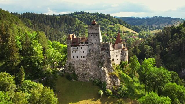 Aerial drone view of The Bran Castle in Romania. Medieval castle in Carpathians, green trees around