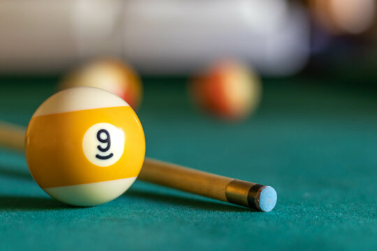 Billiard nine ball on green tapestry Photos | Adobe Stock