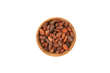 Semillas de Cacao tostadas in wooden bowl on white background, top view