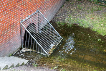 Metal grid storm drain filter barrier. Clean water city channel spring. Grate rain drainage sewage...
