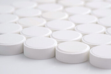 Many white medical pills close up. Pharmaceutical Industry and medicine concept. 