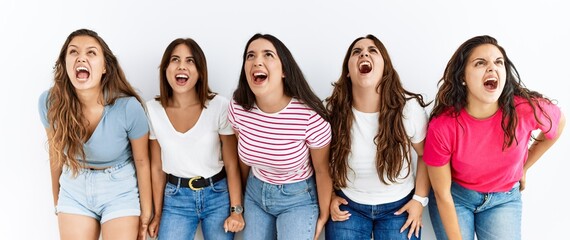 Group of women wearing casual clothes standing over isolated background angry and mad screaming frustrated and furious, shouting with anger. rage and aggressive concept.