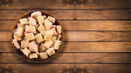 Raw chopped tripe in the wooden bowl - wooden background
