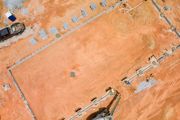 Pouring concrete columns into a new house using a concrete mixer truck was the process an...