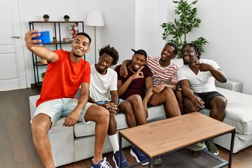 Group of african american people smiling happy make selfie by the smartphone at home.